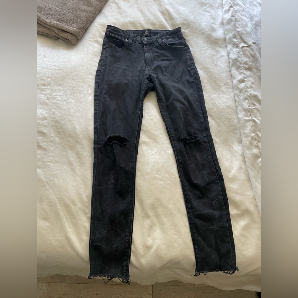 Just black faded black jeans with rip on the knee